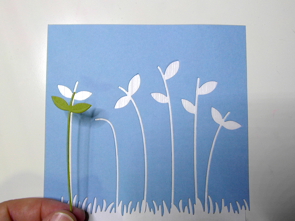 Inlaying die cuts into card panel.