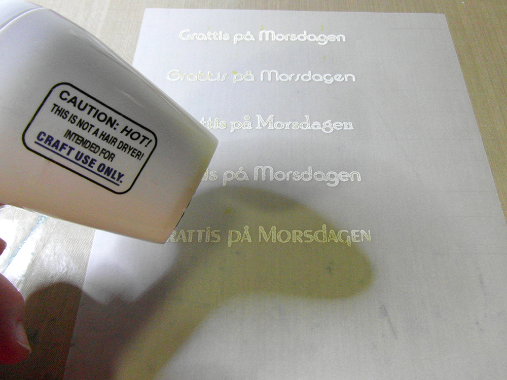 Using heat tool on embossing powder.