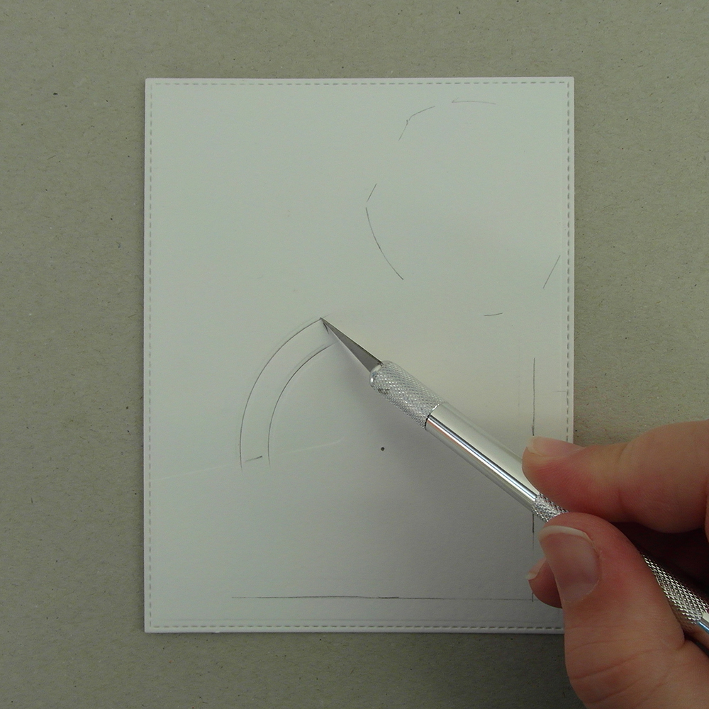 Cutting a groove with a craft knife.