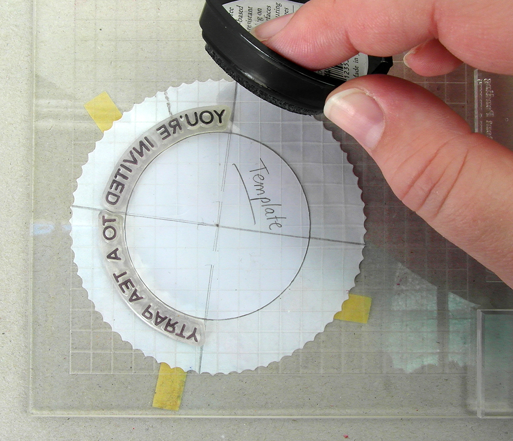 Inking up circular stamp with black ink.