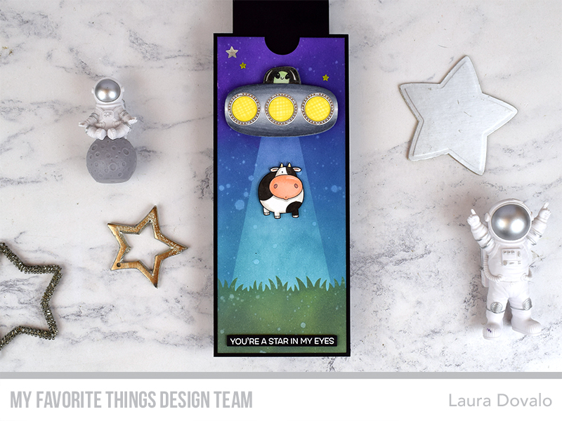 Cenital view of magnetic slider card with UFO and cow.