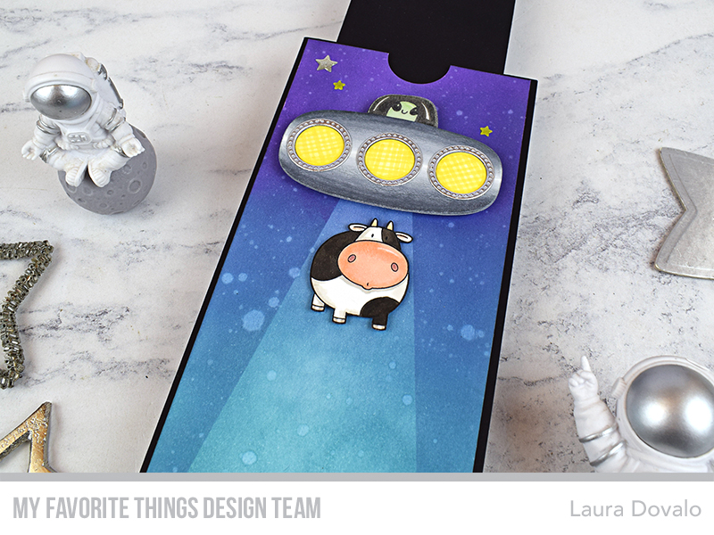Close up of interactive magnetic slider card with UFO.