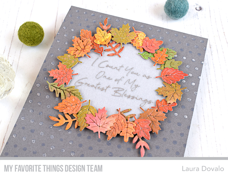 Close up of greeting card with wreath of leaves.